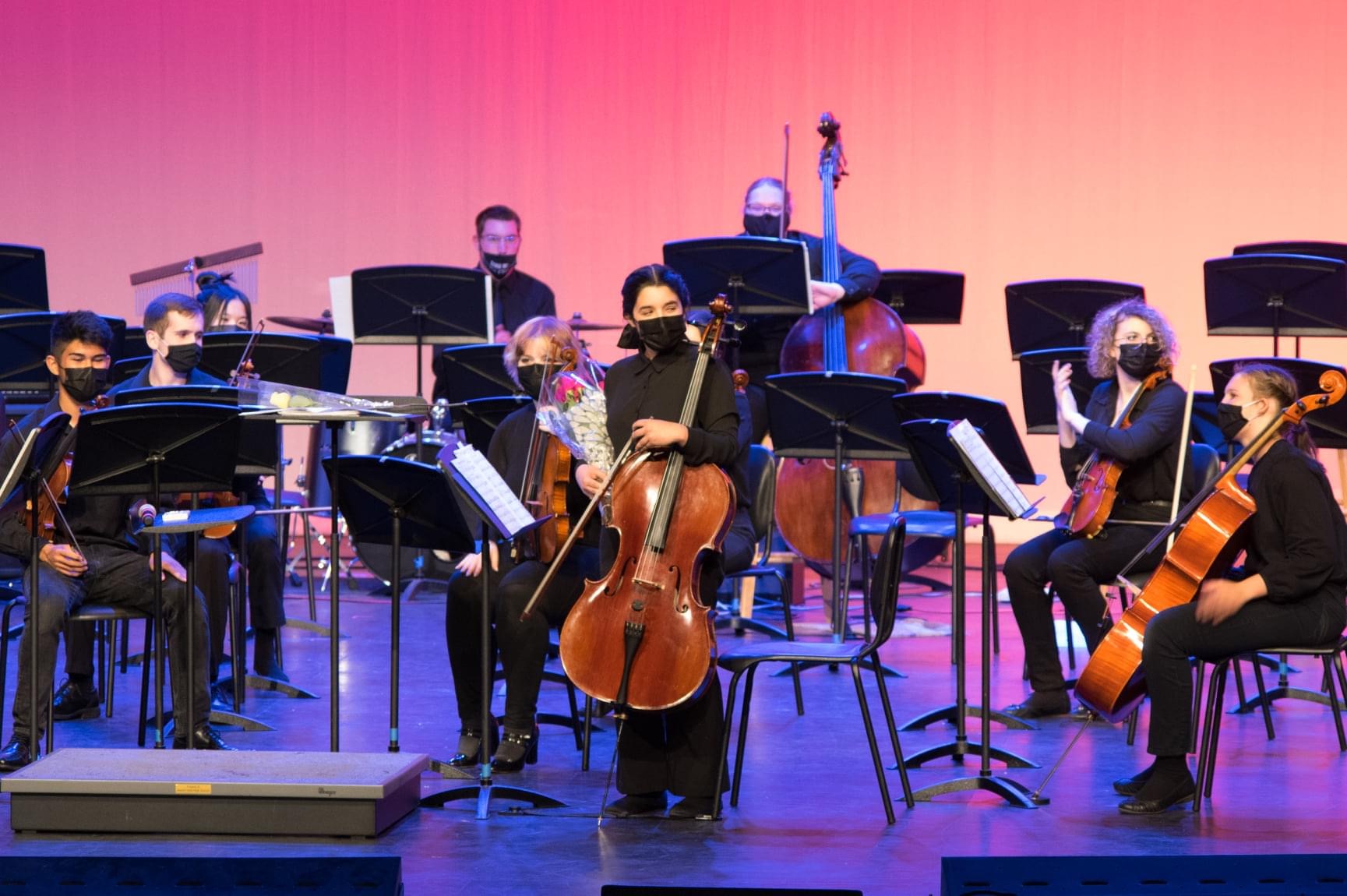 image of me standing in front of the orchestra with my cello after playing a tango solo in our pops concert