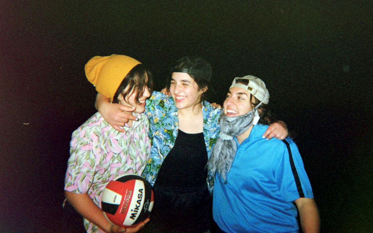 a few of my friends and I dressed as guys laughing after playing volleyball